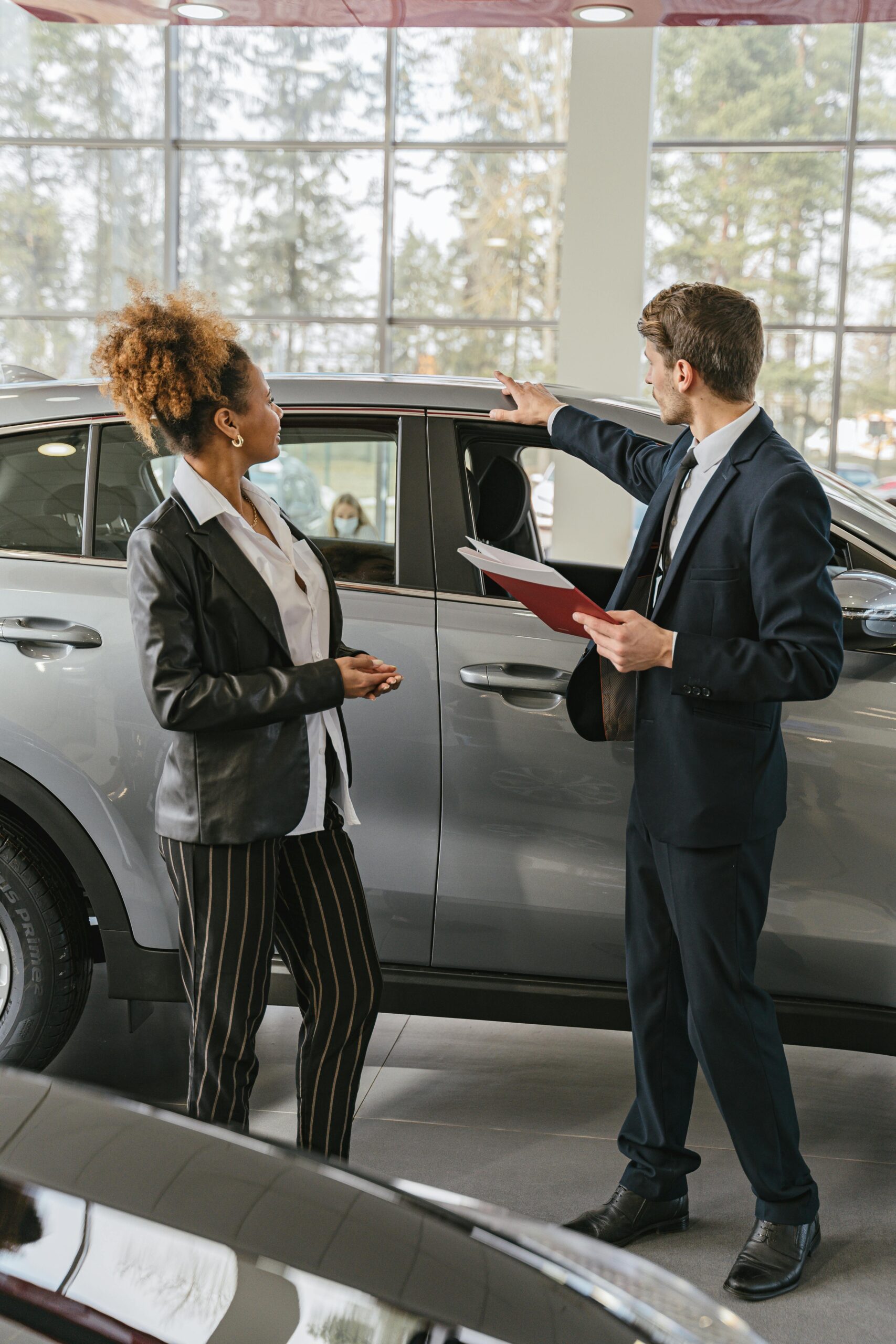 Careful buyer reviewing used car purchase documents
